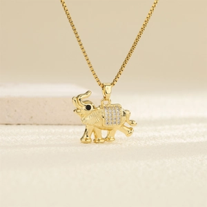 Macro shot of gold elephant pendant with sparkling cubic zirconia on box chain necklace