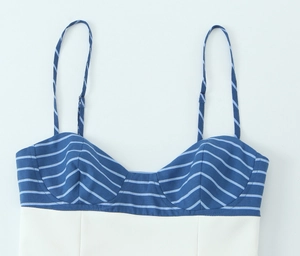 Detail of blue and white striped camisole top with thin shoulder straps and stitching