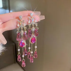 Luxurious silver tassel earrings with pink crystals and pearls in a starburst design