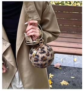 Detail of leopard print ball evening bag with sparkling rhinestone metal ring handle