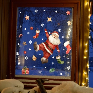 Cozy window scene with Santa Claus and snowflake static cling stickers on dark wood glass