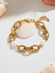 Close-up of 18K gold plated Cuban chain bracelet with pearls and S.steel tag