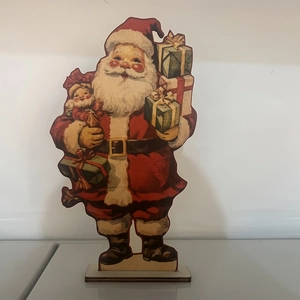 Close-up of vintage wooden Santa Claus figurine holding gifts with stable base