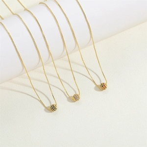 Elegant gold necklaces with round colorful zircon pendants on minimalist display