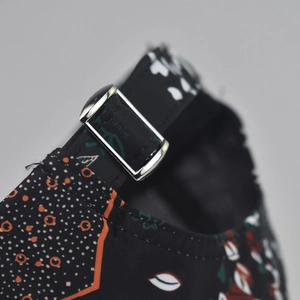 Close-up of baseball cap with floral print and adjustable silver metal buckle strap