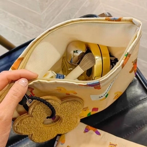 Detailed interior of the canvas makeup bag showing its large capacity for brushes and cosmetics