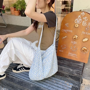 Close-up of blue floral canvas tote bag showing the soft drape and large capacity
