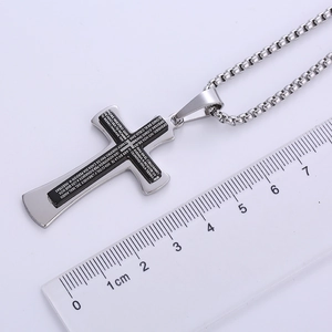 Detail of stainless steel cross pendant with ruler showing size and Spanish scripture