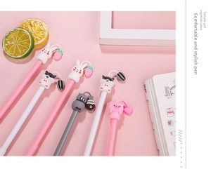 Close-up of cute animal pens with silicone charms like rabbits and cats on pink background
