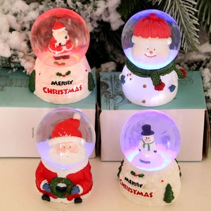 Illuminated Christmas resin glass globes with Santa and Snowman figures on white bases