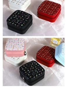 Close-up of portable tweed jewelry boxes in assorted colors with smooth zipper closure