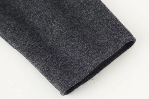 Detail of dark gray wool coat cuff showing high-quality stitching and fabric texture