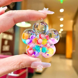 Handheld petal-shaped resin pendant filled with colorful beads and liquid glitter