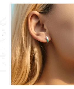 Close-up of S925 silver hoop earring with blue enamel and a heart-shaped zircon