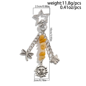 Detailed view of bohemian turquoise keychain with stars, dragonflies and yellow beads