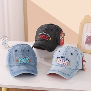 Detail of vintage Miami Beach embroidery on denim baseball caps in three shades of blue