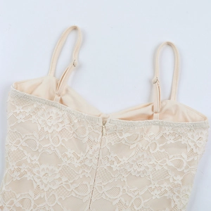 Detail of adjustable straps and hidden back zipper on this beige lace slip dress
