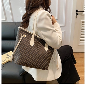 Detailed side view of a large vintage tote bag with geometric pattern on a female model