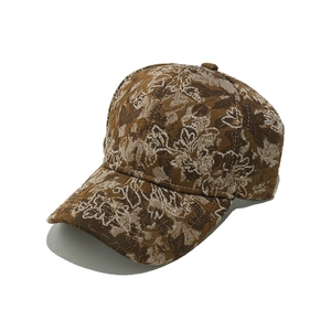 Detailed macro shot of vintage brown and beige floral jacquard fabric on a baseball cap