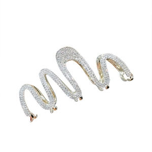 Elegant wave-shaped silver hair claw clip with pavé rhinestones on a white background
