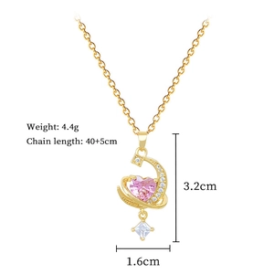 Macro shot of gold moon pendant with pink heart gemstone and jewelry dimensions