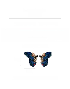 Detail of butterfly earrings with teal fabric texture, rhinestones, and 6.3cm dimensions