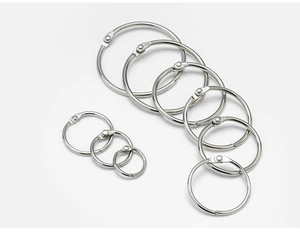 Detailed view of polished silver metal loose leaf rings in various assorted sizes