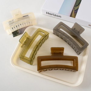 Set of four 13cm oversized shark hair clips in cream, olive green, grey, and amber tones
