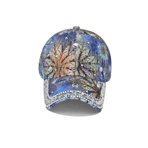 Detail of dark blue floral baseball cap with sparkling rhinestones and silver metal studs