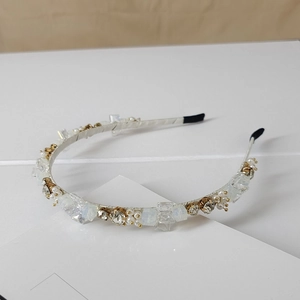 Macro shot of handmade crystal headband with faceted rhinestones and pearls detailing