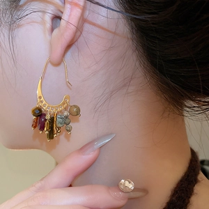 Detail of 18k gold plated fringe earrings with colorful stones on model side view