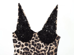 Detail of leopard print fabric with black floral lace stitching on V-neck summer dress