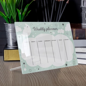 Detailed view of an acrylic weekly planner on a desk with a cute bear and star pattern