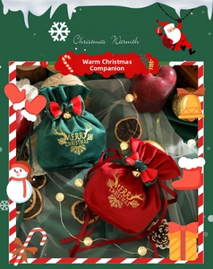 Macro detail of red and green velvet Christmas gift bags with gold Merry Christmas print
