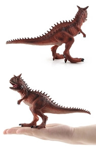 Carnotaurus dinosaur model detail showing textured scales and size comparison in hand