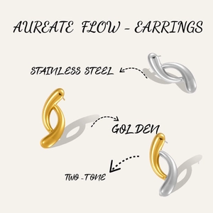 Macro detail of irregular C-shaped stainless steel earrings in gold and silver finish