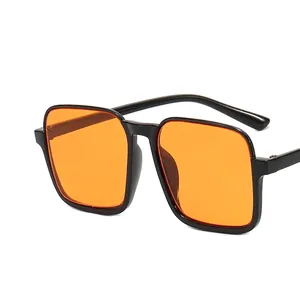 Vintage oversized square sunglasses with black frame and vibrant orange tinted lenses