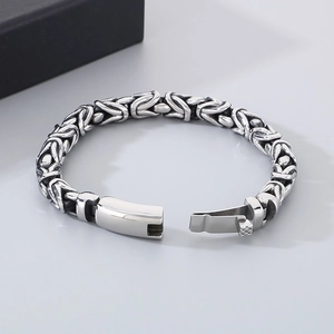 Close-up of a silver Byzantine chain bracelet with vintage finish and secure clasp