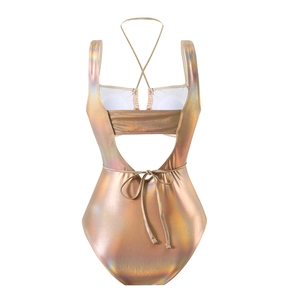 Detailed back view of laser gold halter swimsuit featuring cross straps and lace-up design