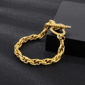 Detailed macro view of the golden twisted rope chain with a classic T-bar toggle clasp