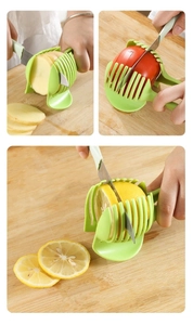 Detail showing multifunctional green slicer cutting lemon and tomato on a wooden board