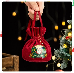 Close-up of red velvet Christmas apple bag with Santa Claus and Merry Christmas print