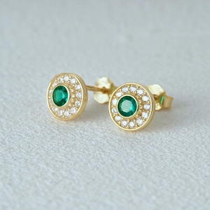 Close-up of S925 silver round emerald cat eye stud earrings with gold plating and crystals