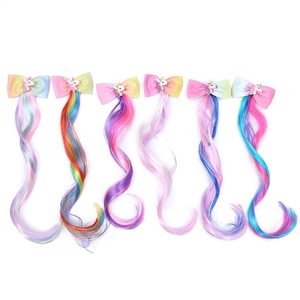 Detailed view of six colorful unicorn bow hair clips with rainbow gradient hair extensions