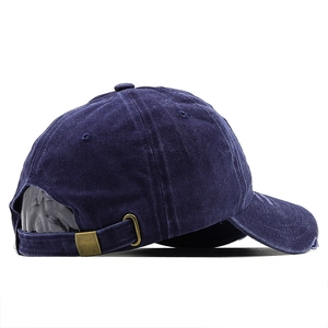 Detail view of navy blue washed cotton baseball cap with adjustable metal slide buckle