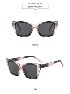 Detail view of retro cat-eye sunglasses with gradient black pink frames and gray lenses