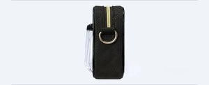 Detail of black quilted fabric bag with clear PVC pocket and gold D-ring hardware