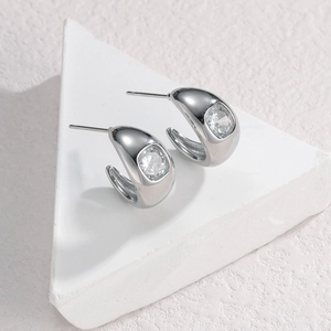 Silver C-shape earrings with a square-cut zircon stone on minimalist white stone
