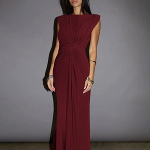 Detail of the twisted waist pleats on a burgundy sleeveless floor-length dress