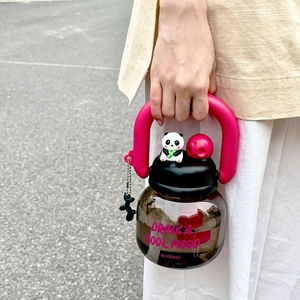 Detail of cute brown large capacity plastic water bottle with pink handle and panda ornament
